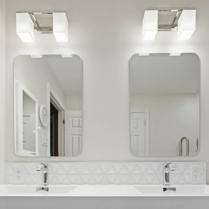 a bathroom with a couple of mirrors